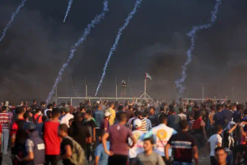 Palestinians marching on the separation wall