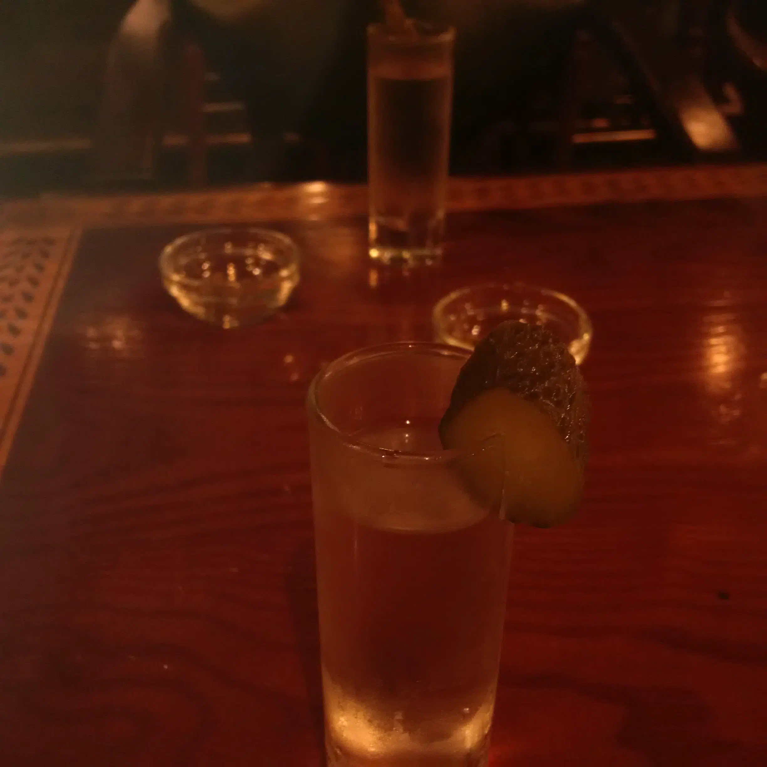 A shot of vodka with a slice of pickle
