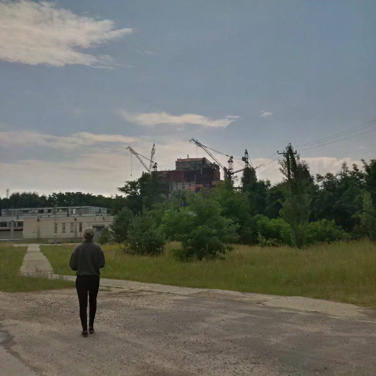 Woman standing in front of the Chernobyl reactor