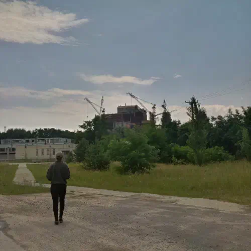 Woman standing in front of the Chernobyl reactor