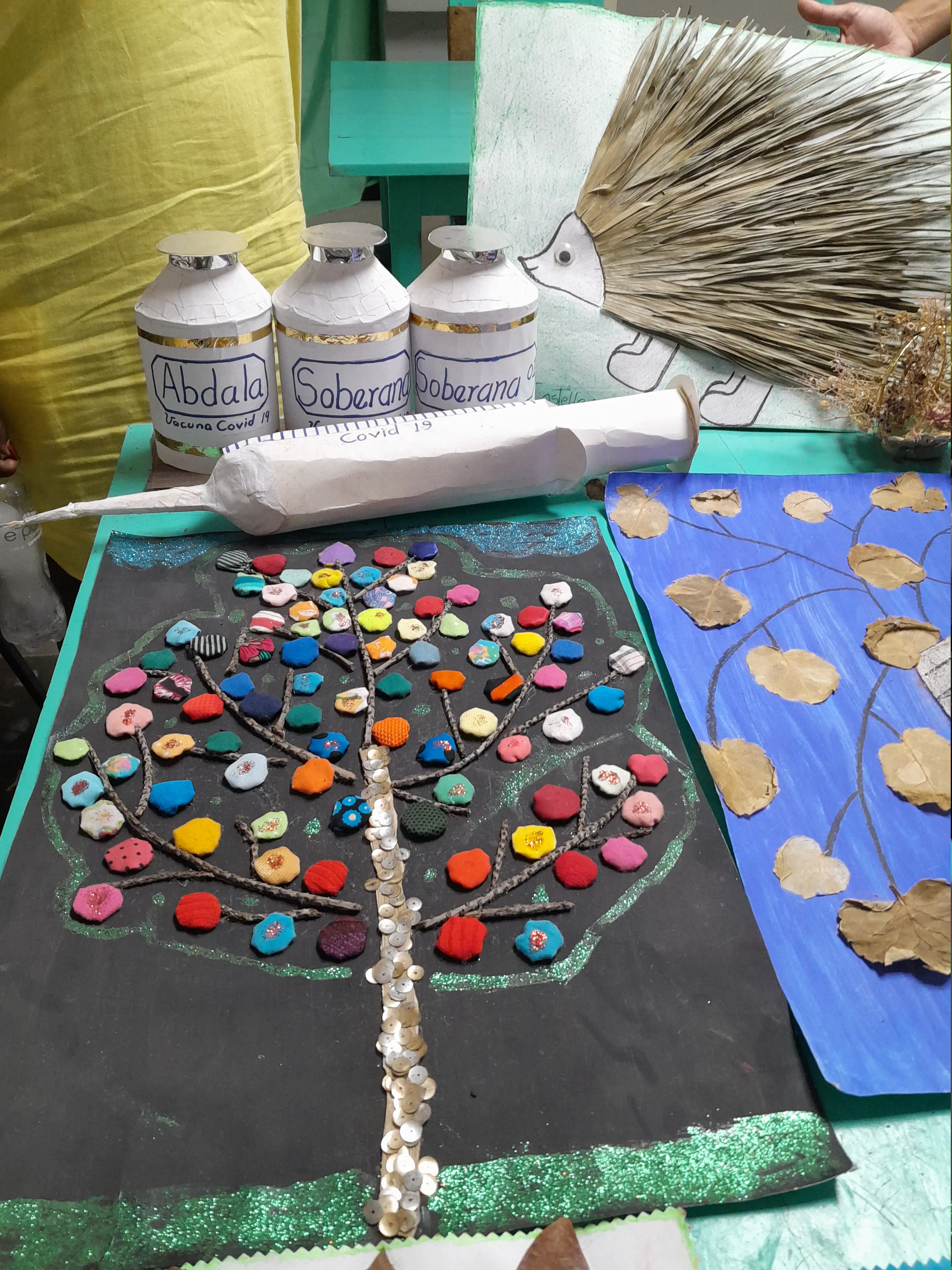 Various arts and crafts, including models of vaccines and a syringe