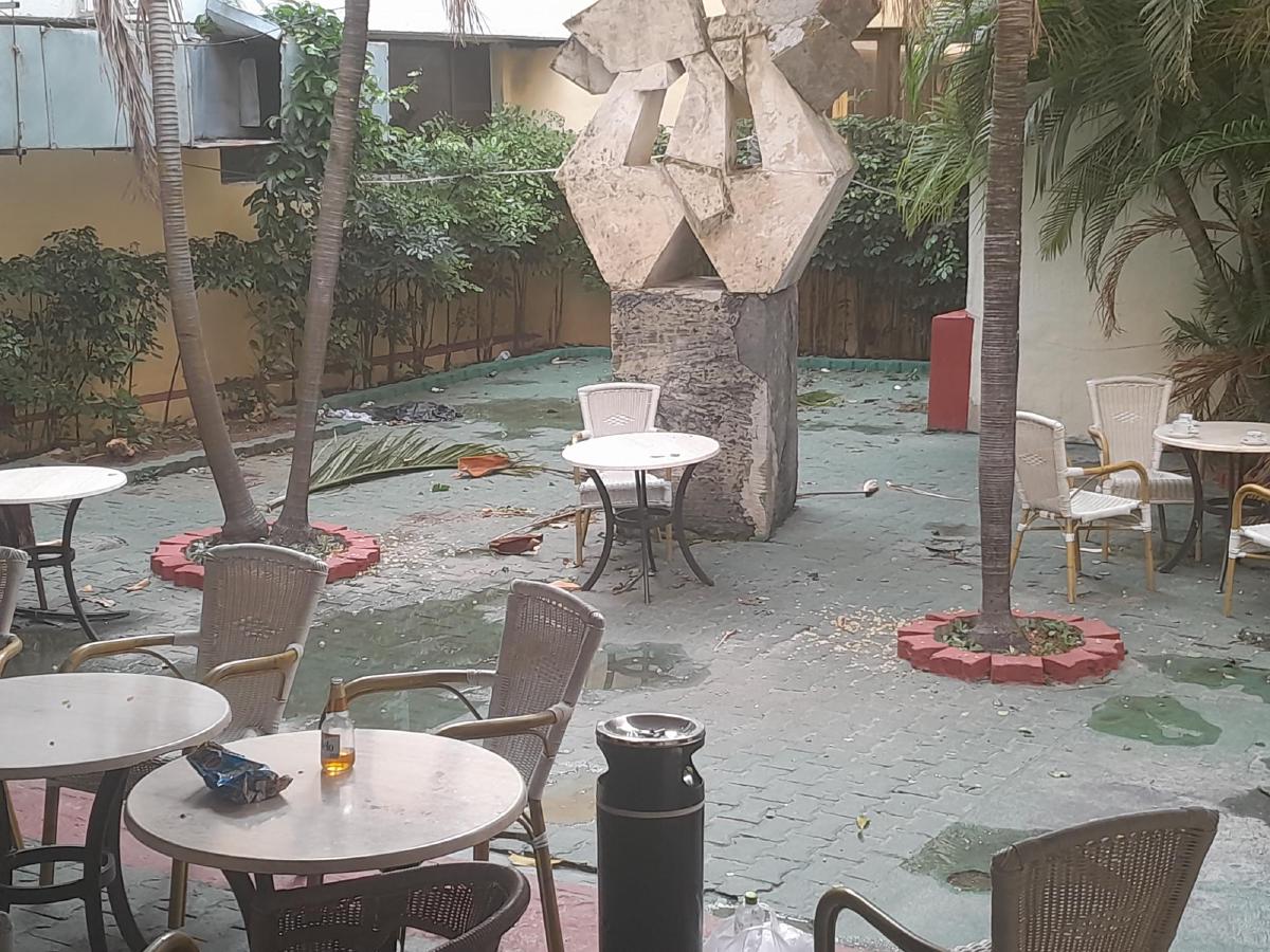An outdoor seating area covered in pools of water and bits of detritus