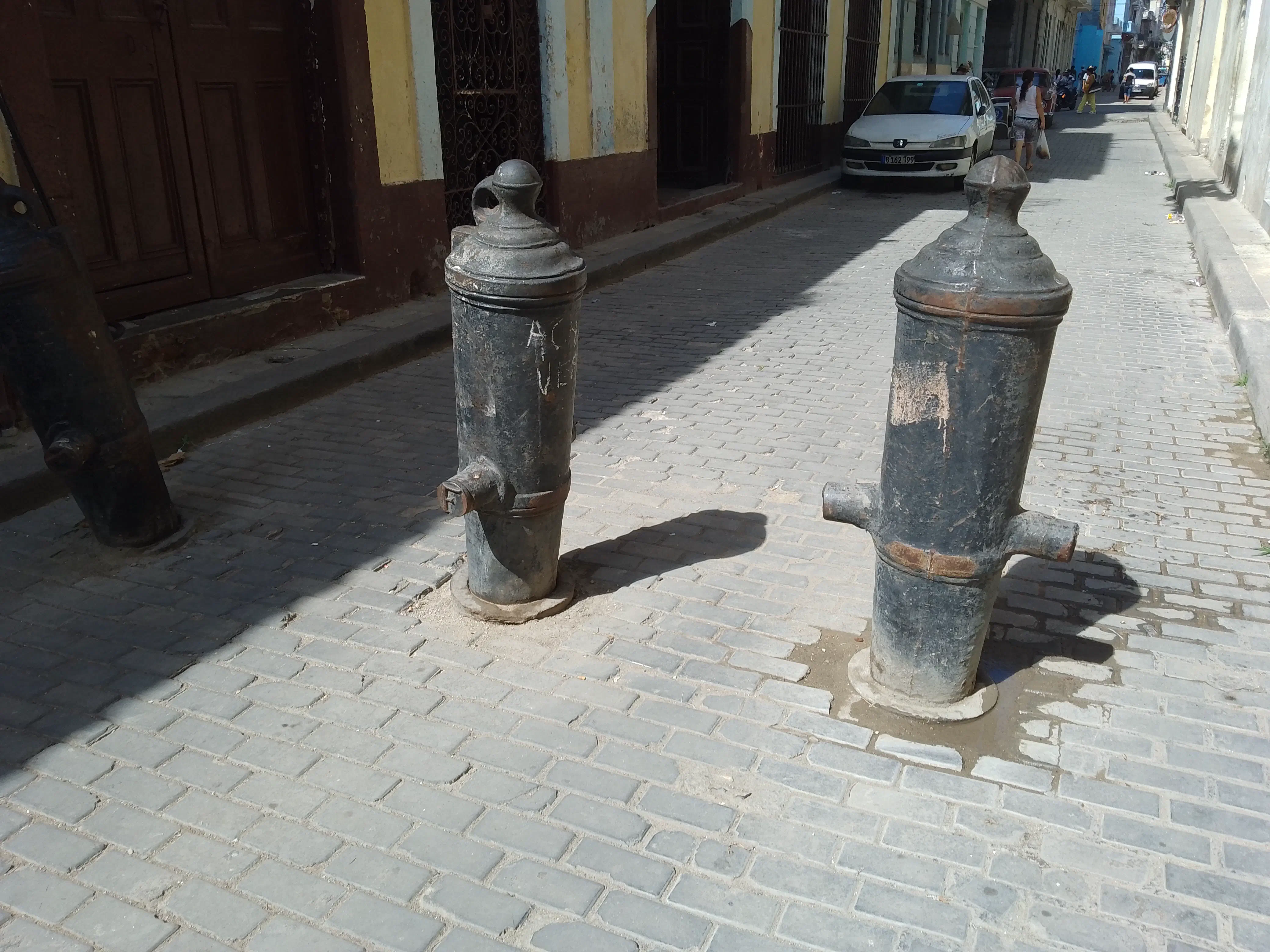 Old cannons mounted into the pavement for use as bollards