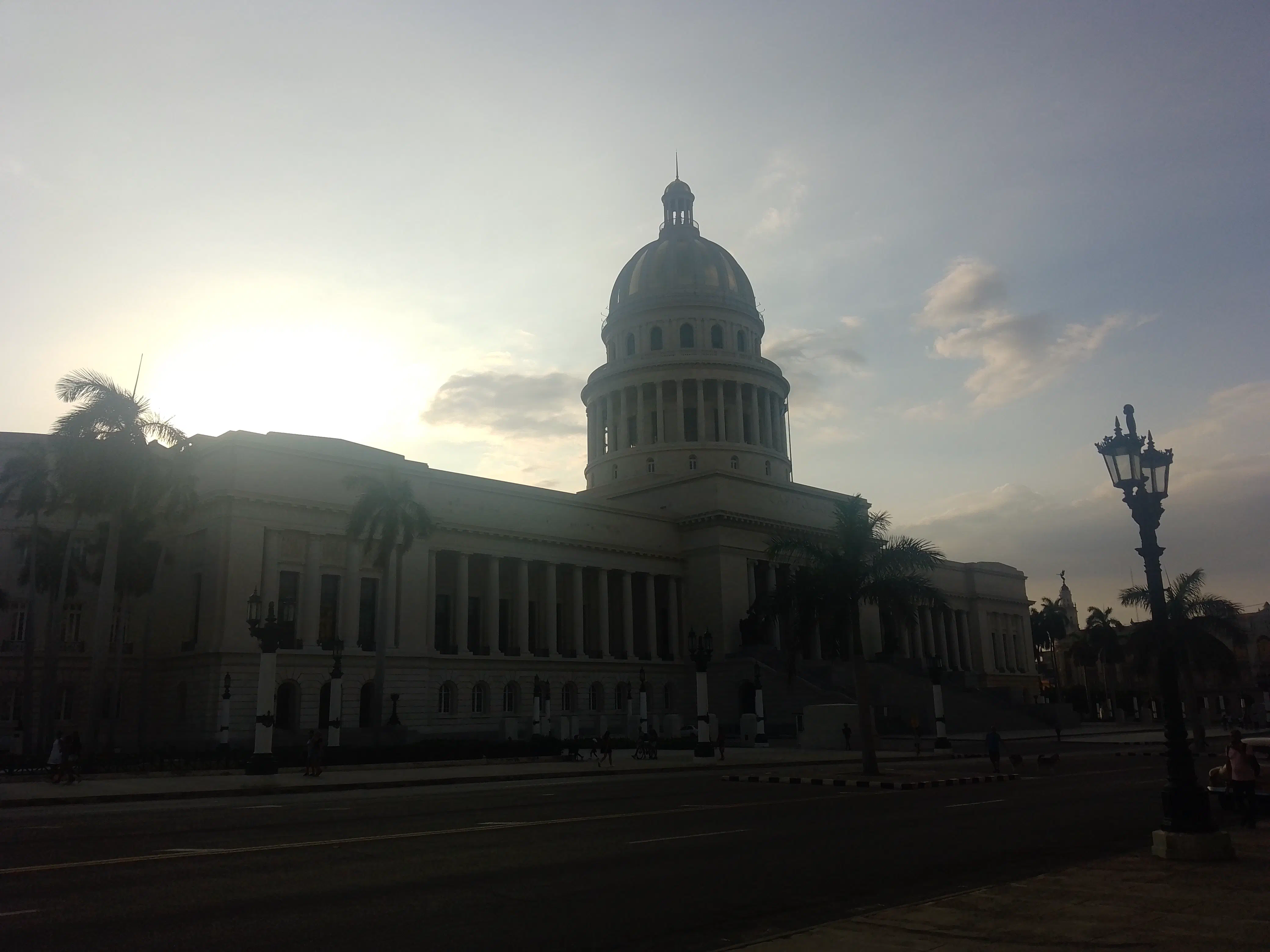 The sun setting behind the dome of the Cuban Capitol Building