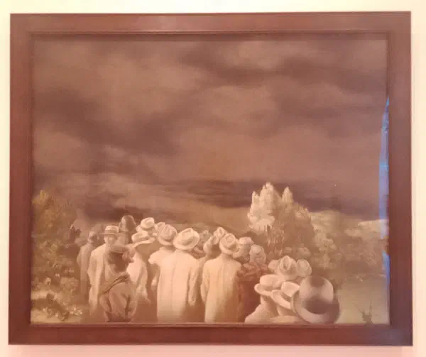 A group of men and women standing in a gloomy landscape