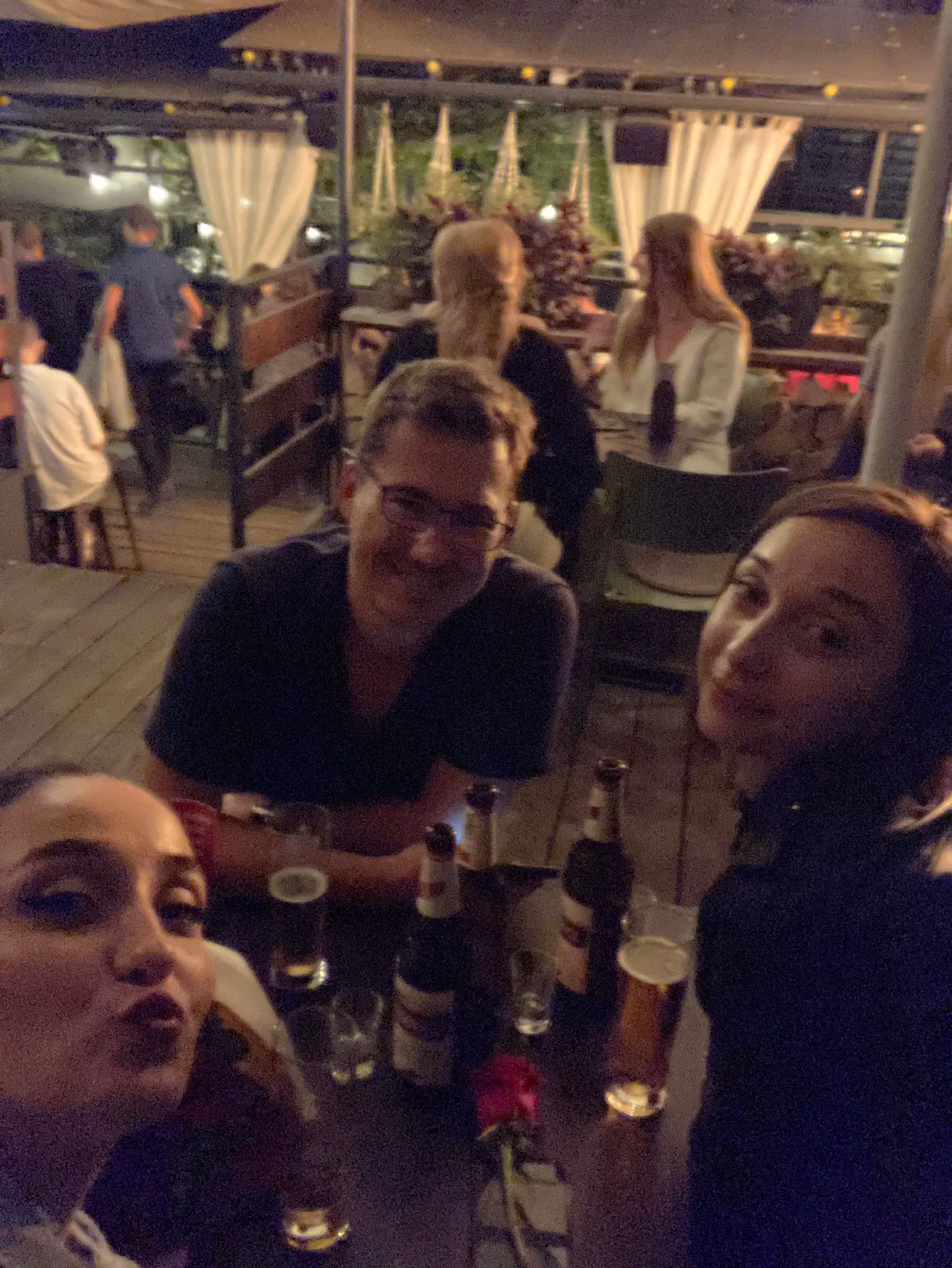 Three people drinking at a bar