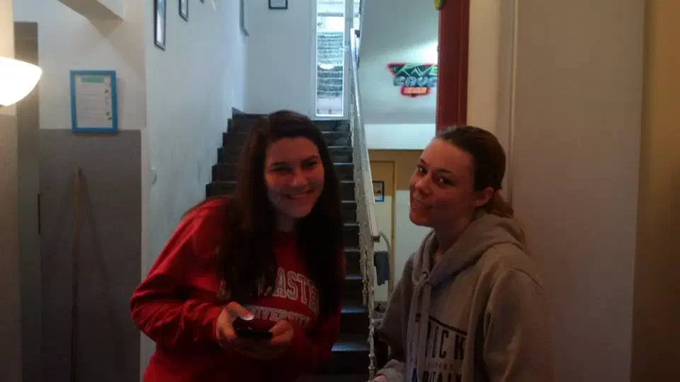 Two girls posing in a hostel staircase