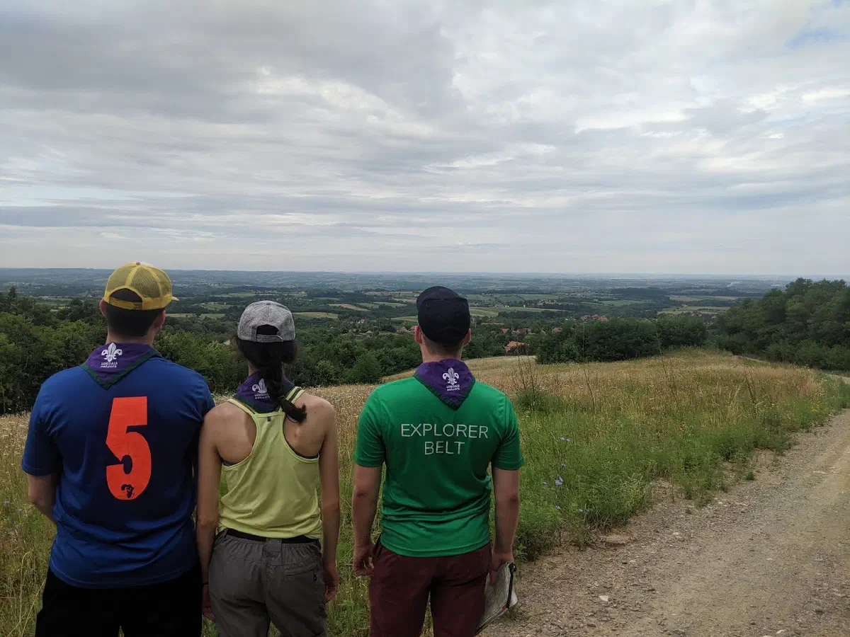 Four people seen from by behind, looking out over the Serbian landscape
