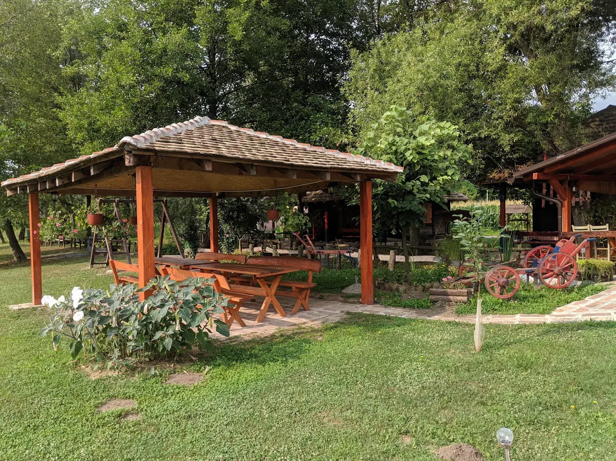 A picnic bench area in a nicely-manicured garden