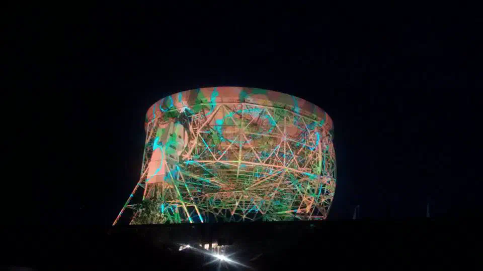 Light installation displayed onto the Jodrell Bank Observatory