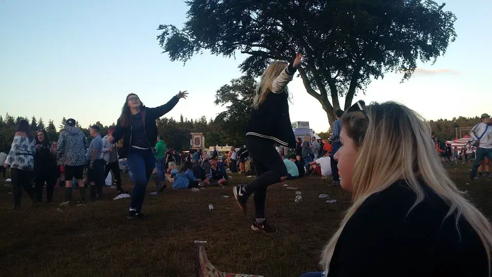 Two girls dancing beneath a tree