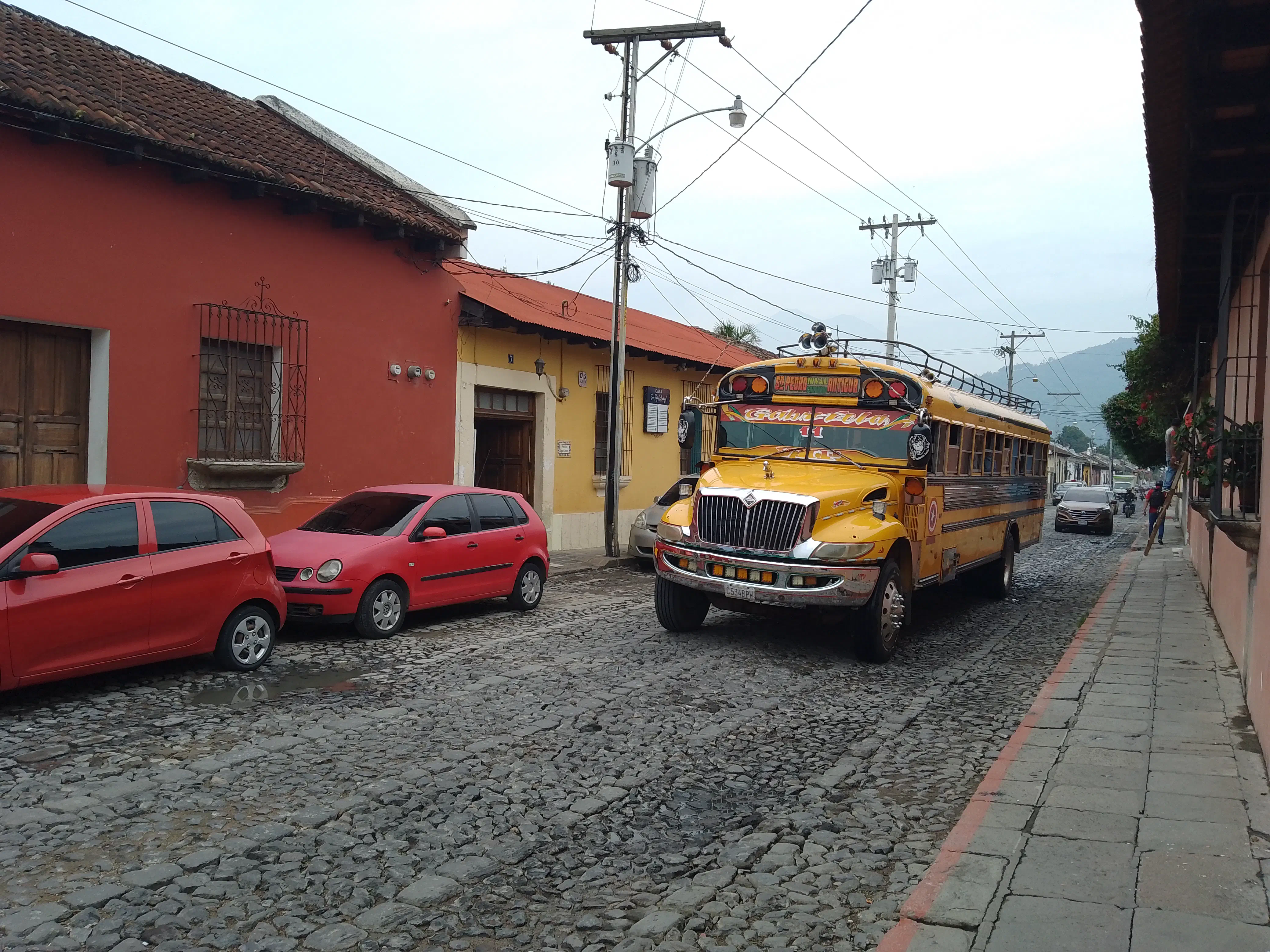 A garishly-decorated US school bus driving through the streets