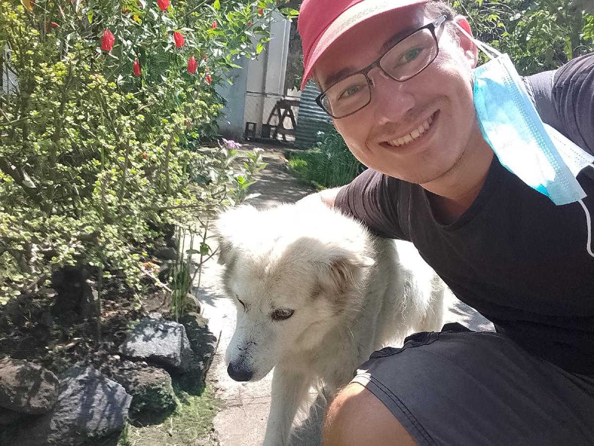 The author taking a selfie with an old white dog