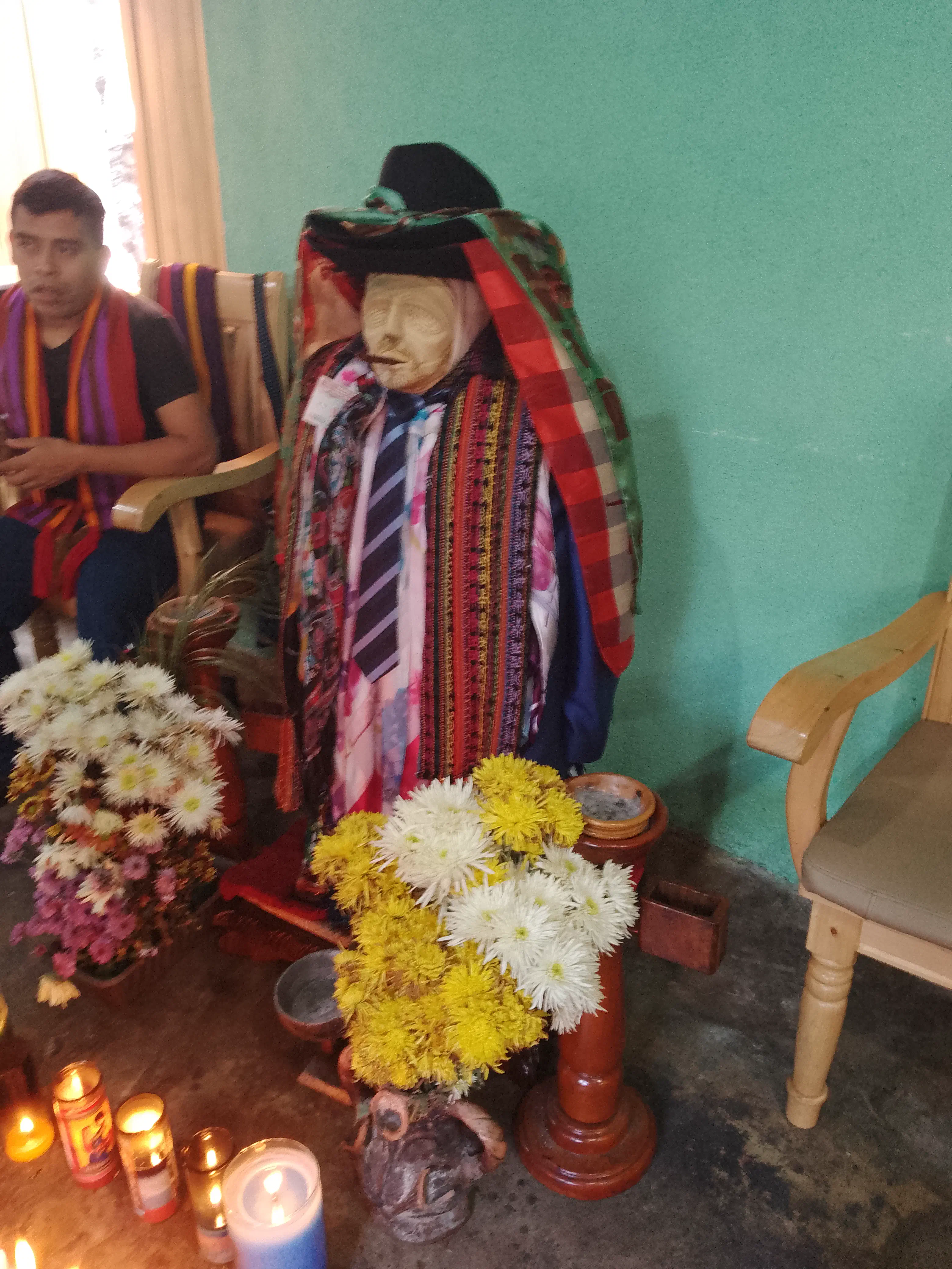 A figure of a man with no arms or legs, decked out in hats and ties