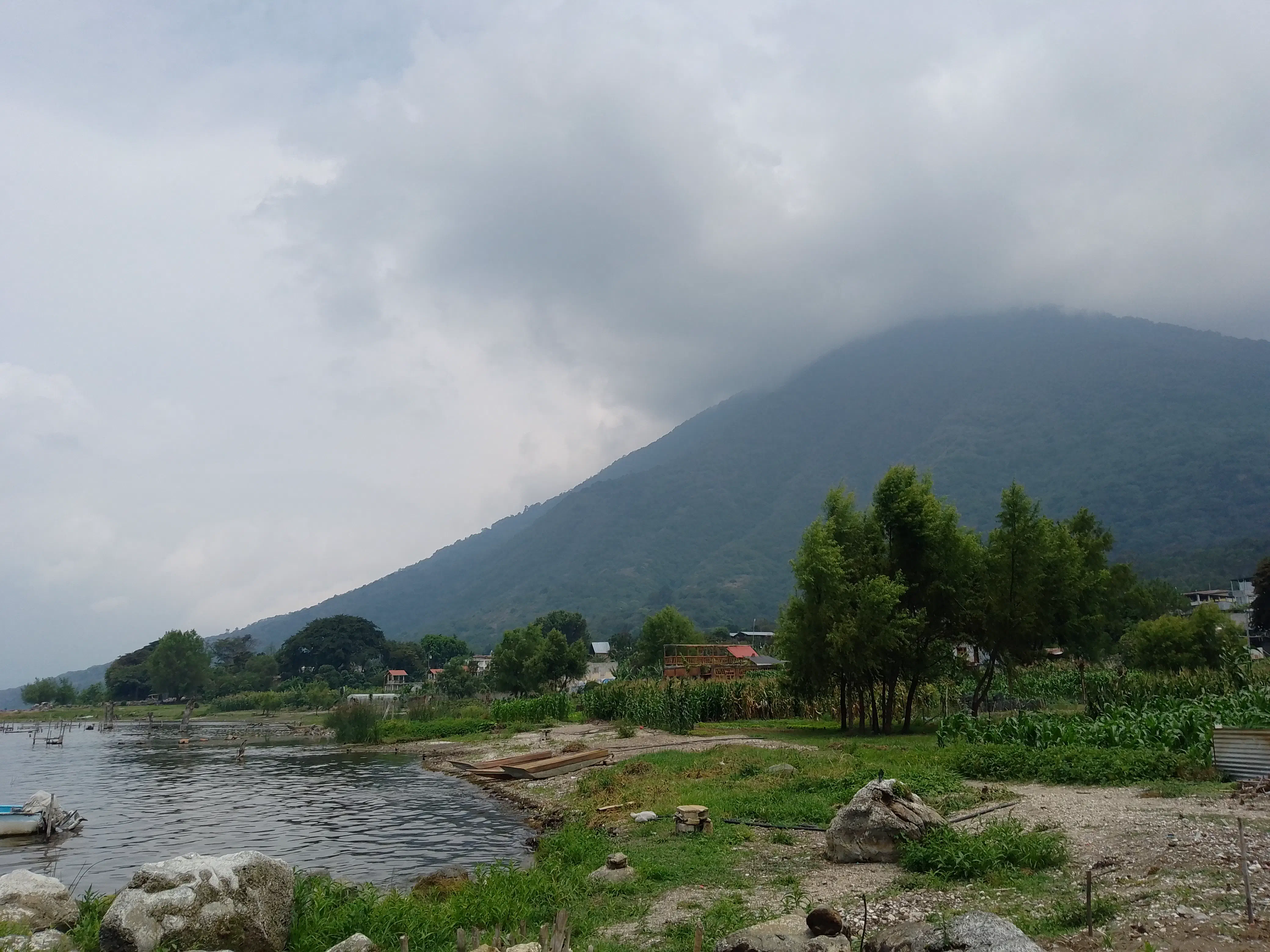 A volcano disappearing into thick clouds