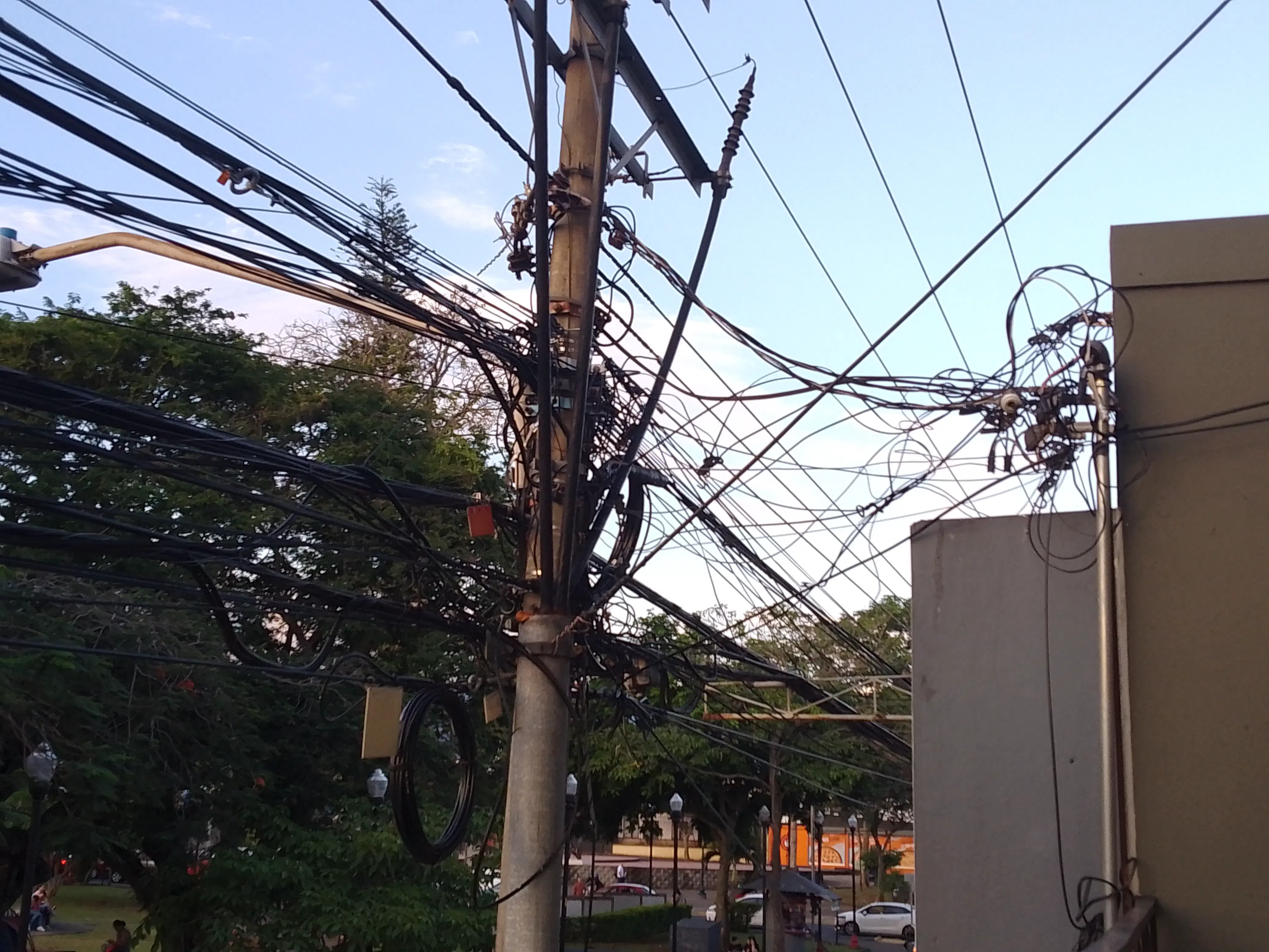 A complicated tangle of wiring around a power line