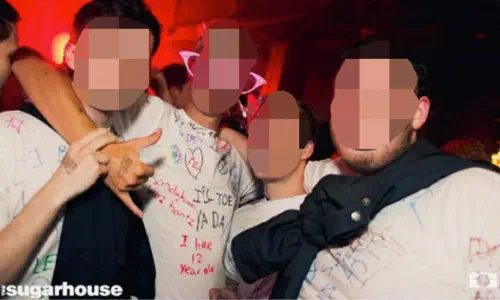 Students at a nightclub wearing white T-shirts