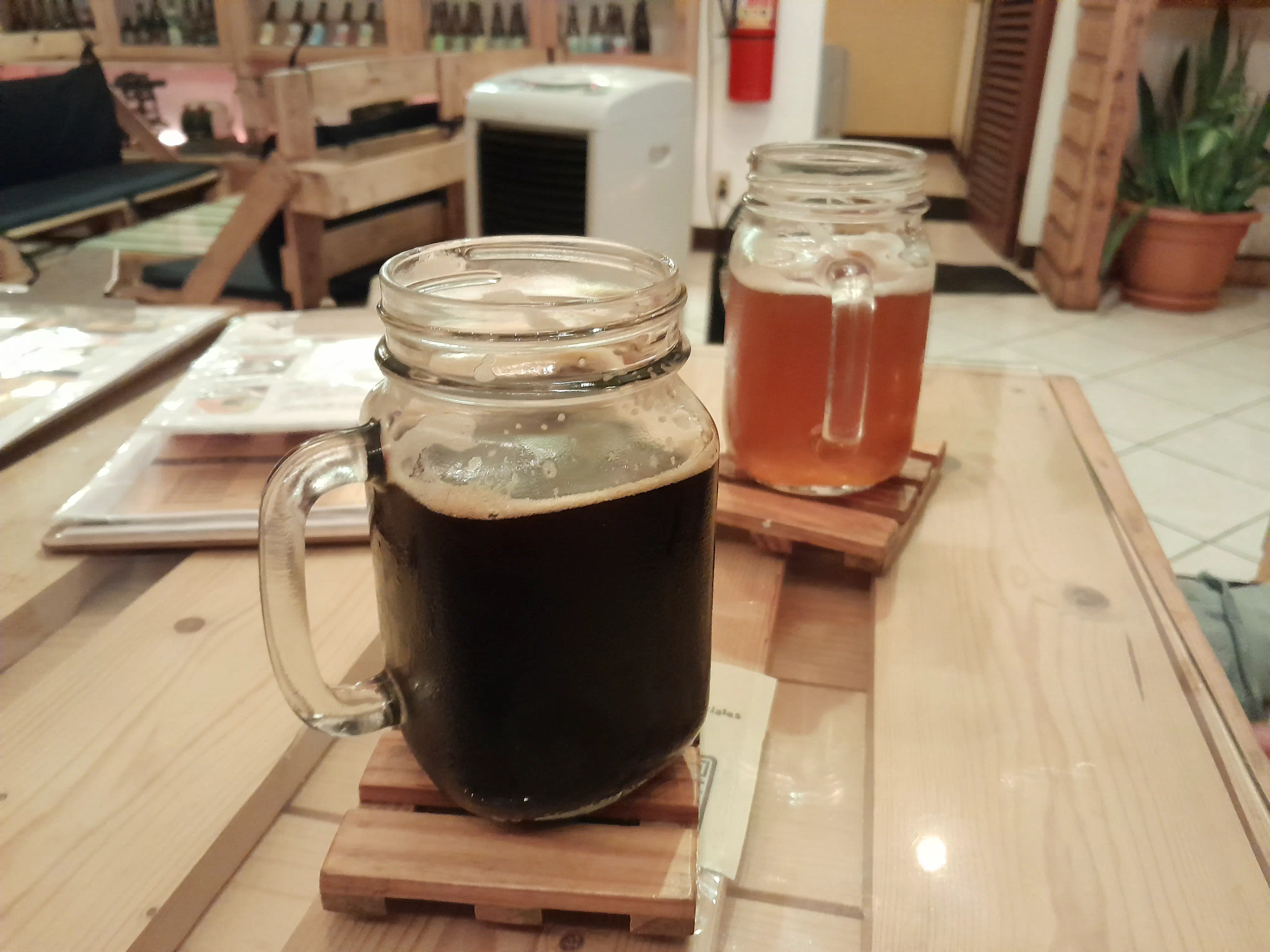 A mason jar filled with dark ale