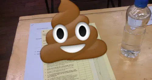 A desk with an exam and bottle of water, with a poop emoji over it