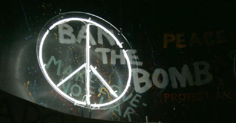 CND symbol in front of graffiti reading 'Ban the bomb'