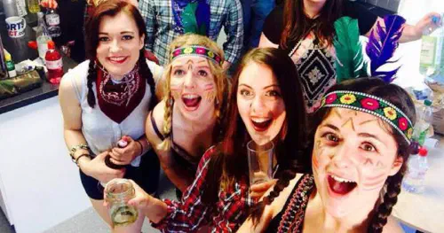 Students partying dressed as cowboys and Indians