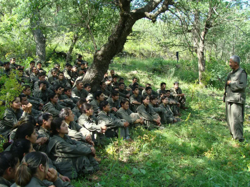 A group of PKK militants listening to a man