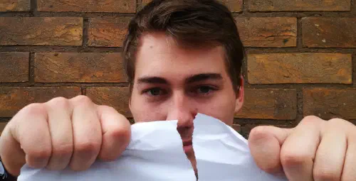 The author tearing a piece of paper