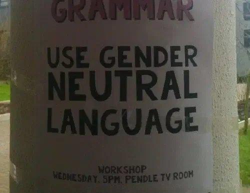 A poster on a piller that reads 'Use gender neutral language'