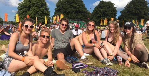 Group of people laying in the grass at a festival