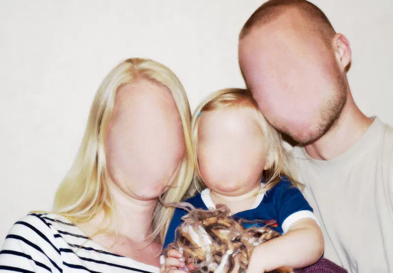 A family with blurred-out faces, representing the experience of prosopagnosia