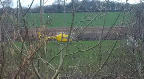 Helicopter landing in field