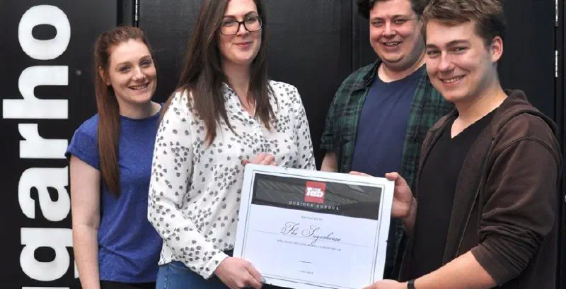 The author handing a Tab-branded certificate to the managers of the Sugarhouse