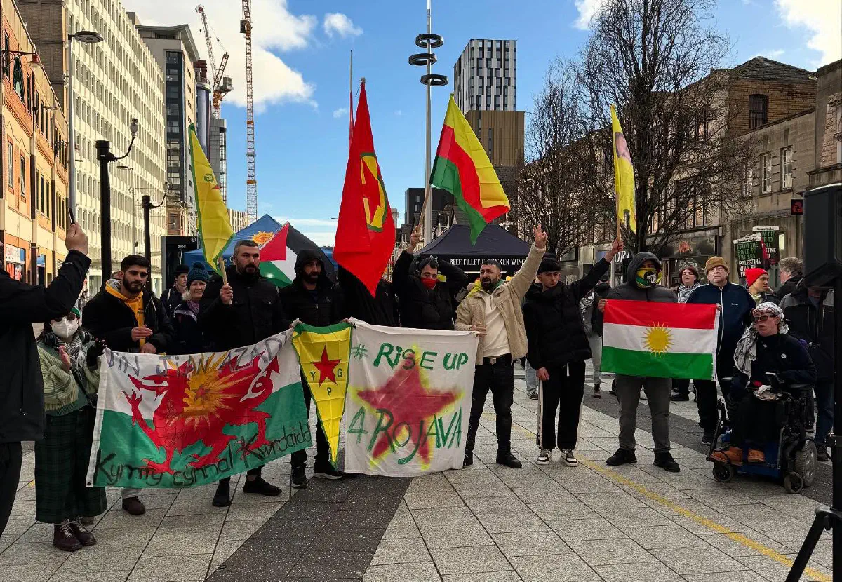 A group of people demonstrating in solidarity with Rojava