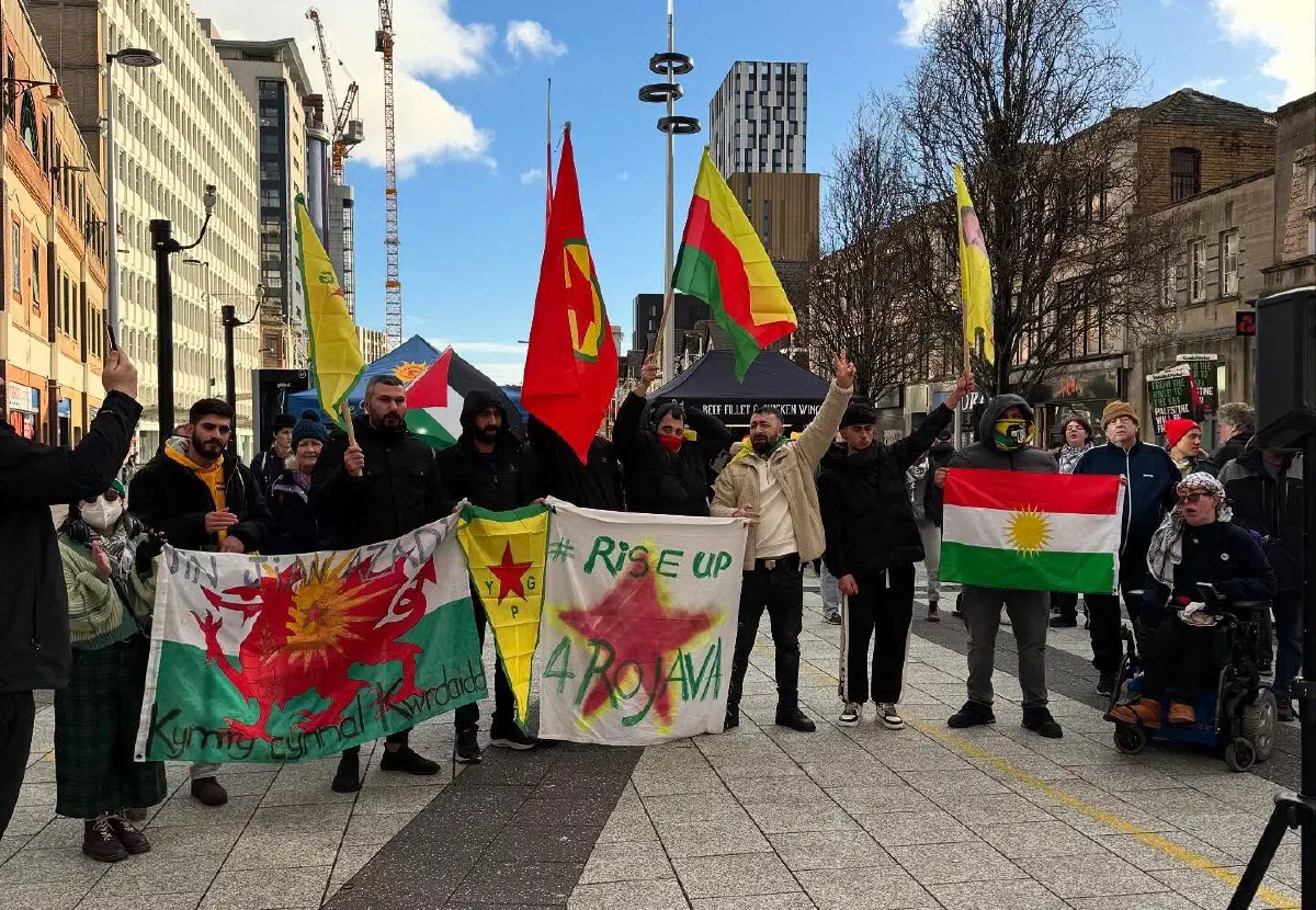 A group of people demonstrating in solidarity with Rojava